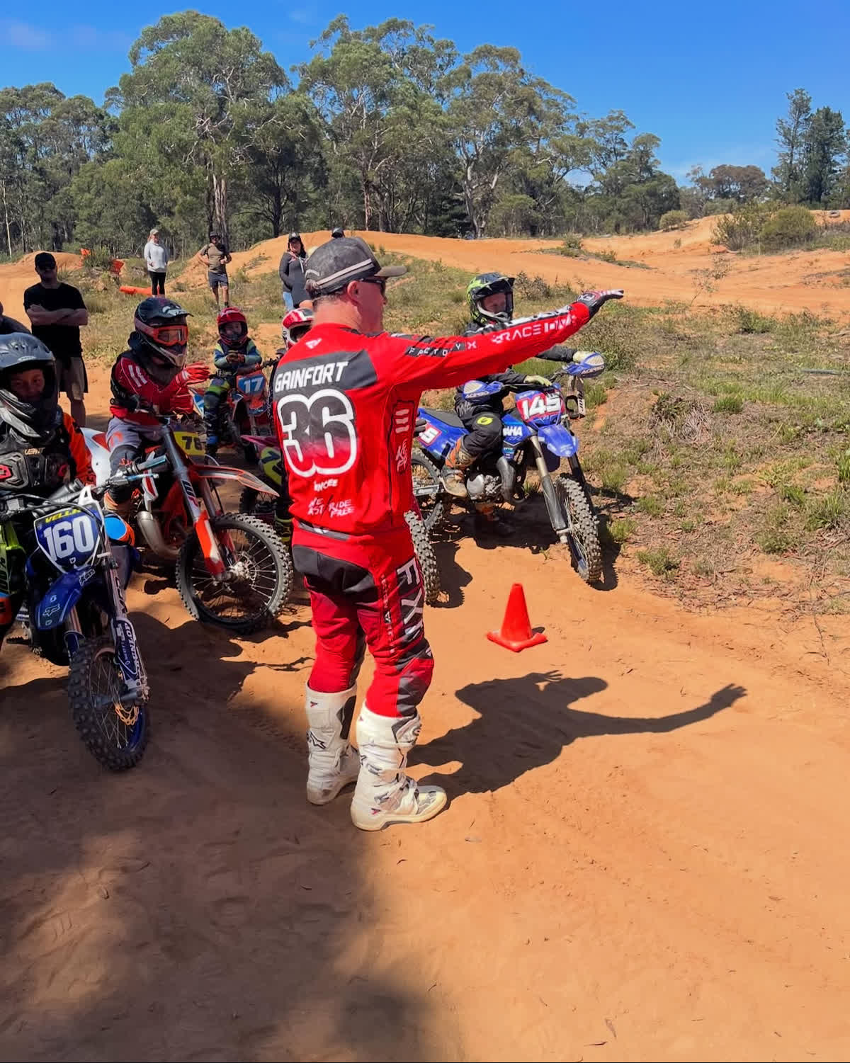Moto Coach rider carving through a berm under instruction